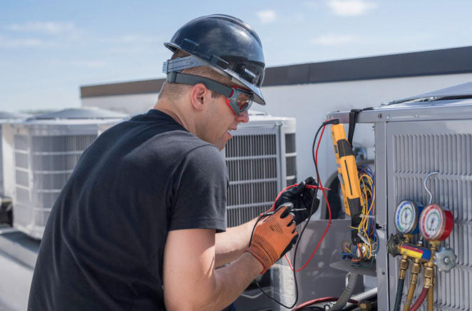 A worker inspecting the HVAC system