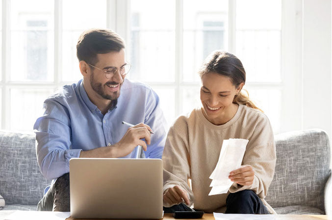 A couple sitting on a couch planning and discussing on the budget 