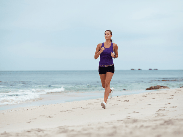 A lady running on the beach.