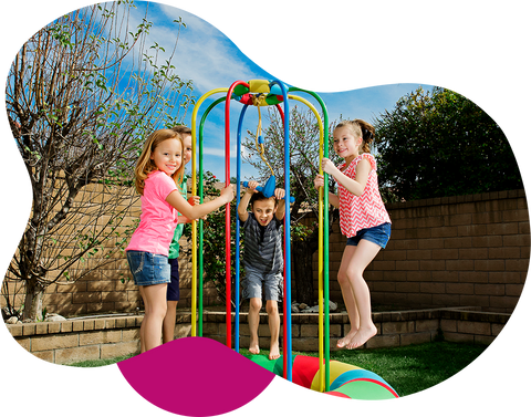 Three girls jumping on their Jungle Jumparoo at a park