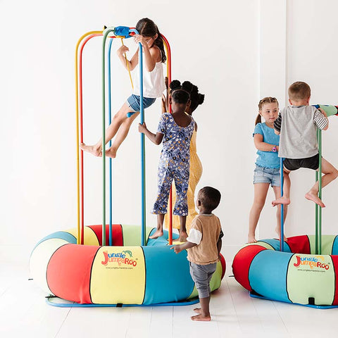 Several children play carefree on their Jungle Jumparoo.