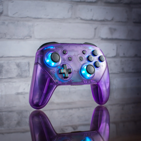 Clear purple Nintendo Pro-Controller with backlit LED buttons.