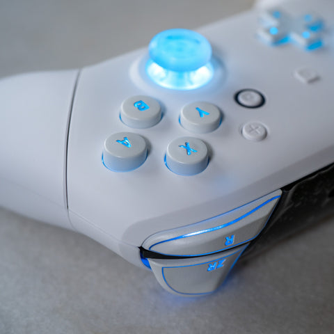 White Nintendo Pro-Controller with LED backlit buttons.