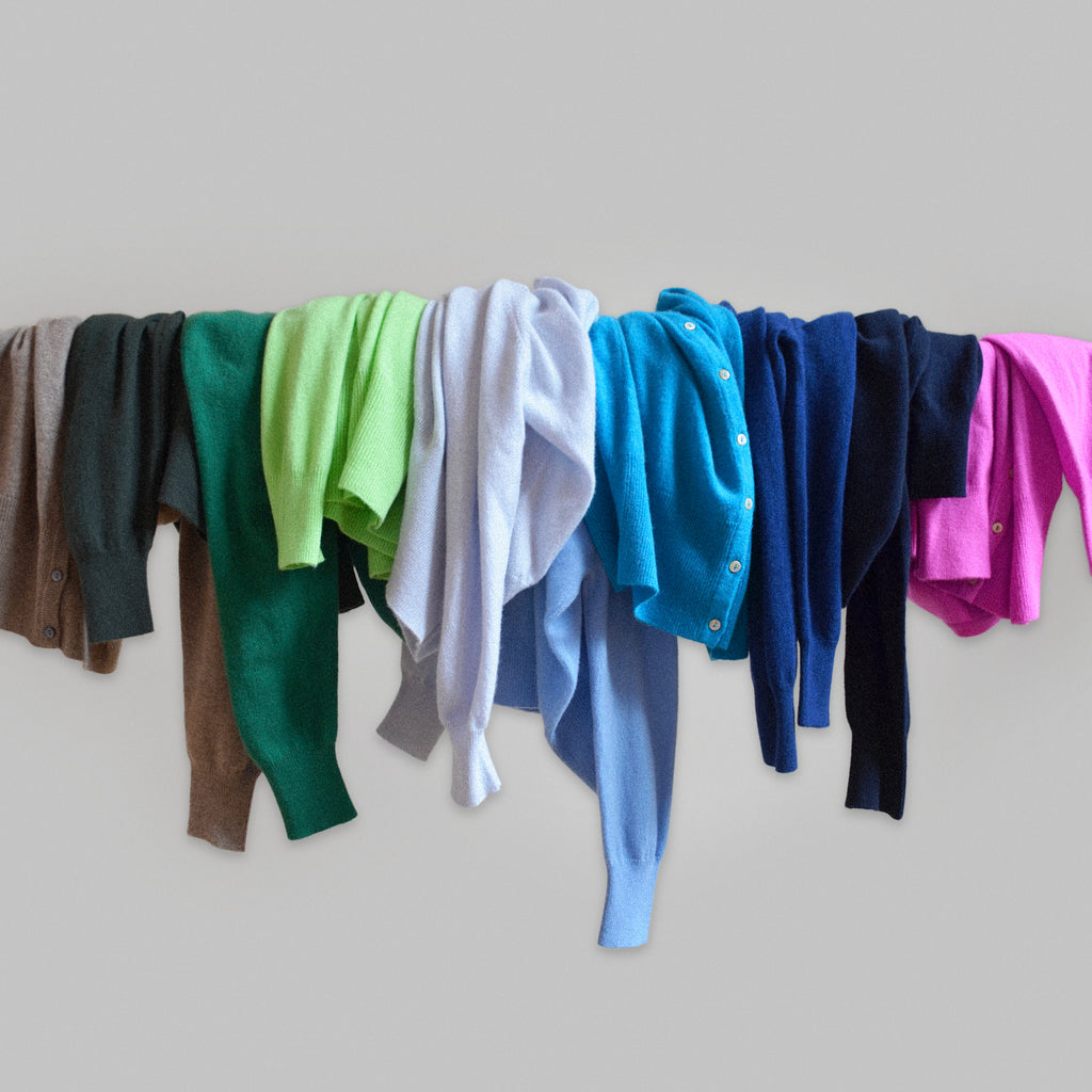 Array of cashmere cardigans draped over a rail