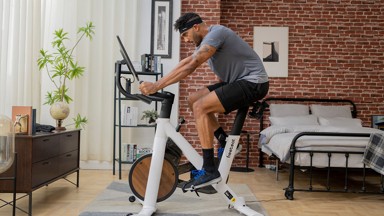 a man is cycling at home to train core muscles (abs, obliques, and lower back)