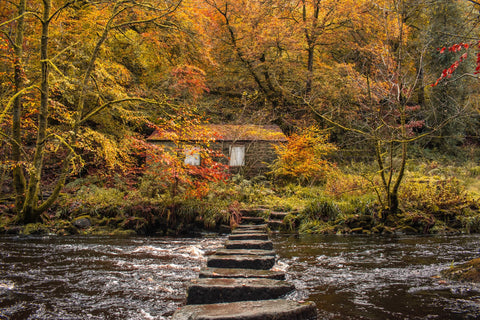Abandoned building on a riverside walk with stepping stones near Hebden Bridge