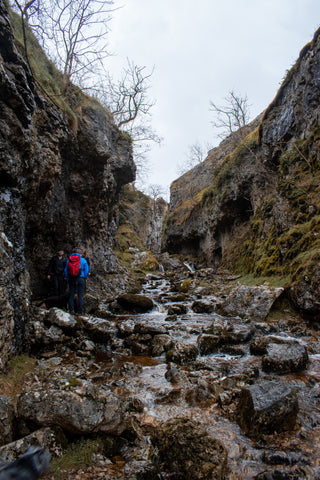 People stand at the entrance to a gorge