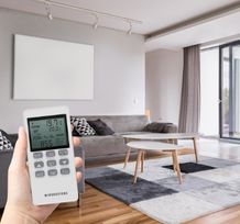 White infrared heating panel in living room viewed from front