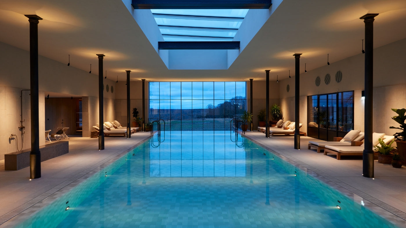 indoor pool with skylight and padded loungechairs