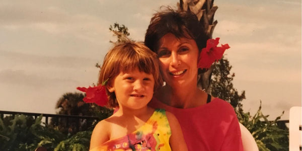 Women and child with red hibiscus flowers in hair