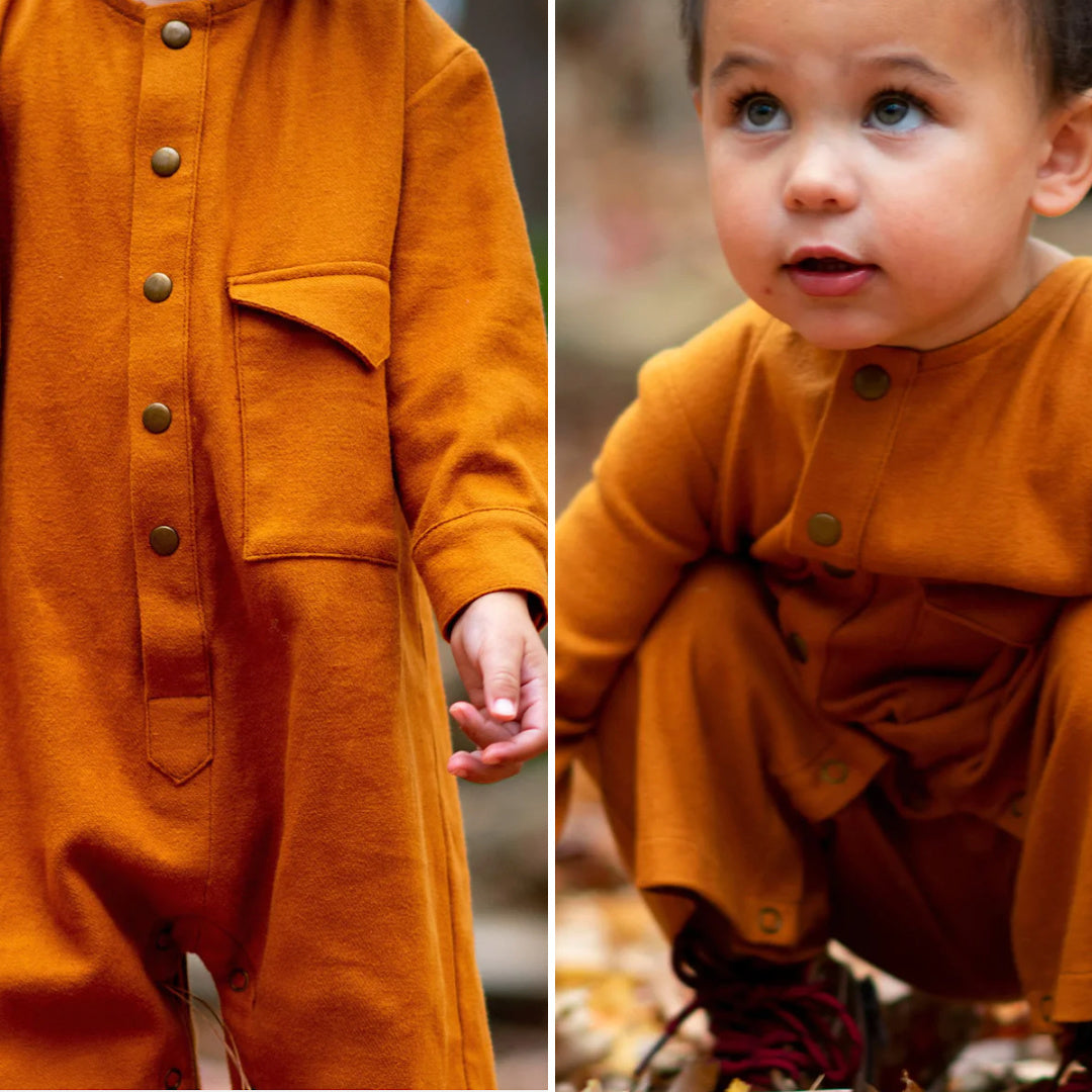 Toddler in orange jumpsuit with buttons