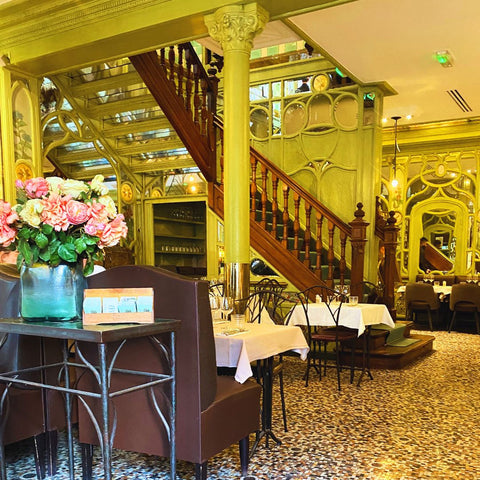 Bouillon Racine restaurant Paris France wooden staircase tables and desk with flowers
