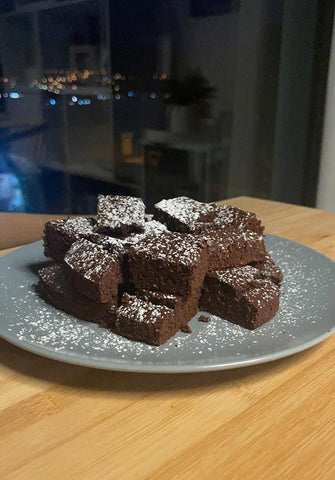 Plate of gluten free chocolate cake bites dusted with icing sugar