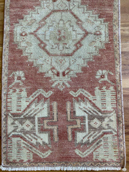 Dimensions: 1'4" x 2'10"  Palette includes a soft red, hints of orange and taupe, off white  Vintage Turkish approximately 50 years old. Wool. 
