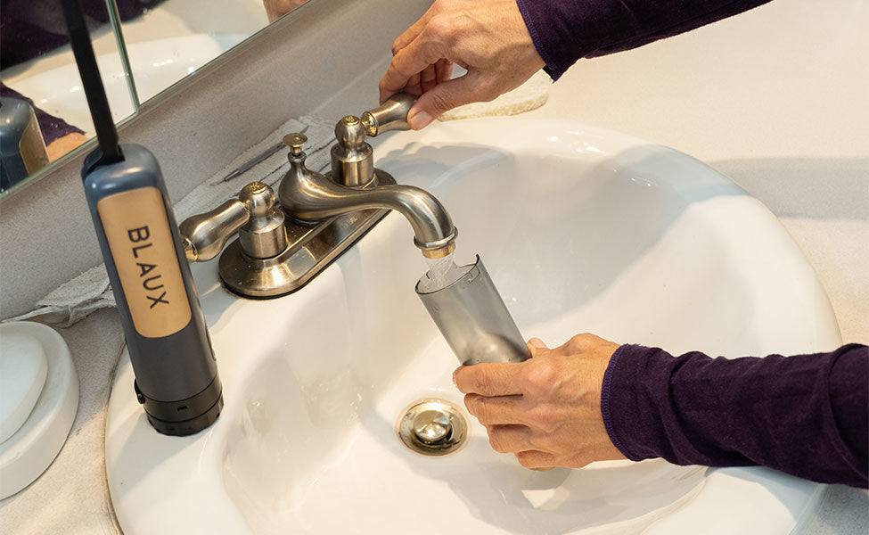 Women filling Blaux Portable bidet with water