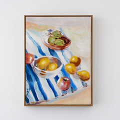 framed still life oil painting of fruit on a navy and white picnic rug