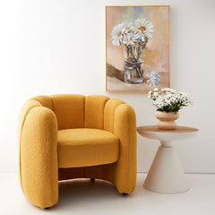 Stylized interior white side table, ceramic vase, floral oil painting and mustard boucle armchair