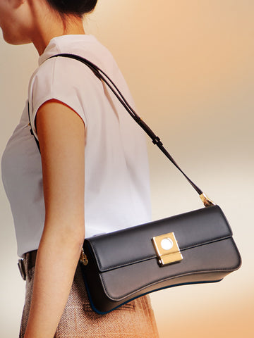 Close-up of a woman carrying the Timekeeper Baguette Bag