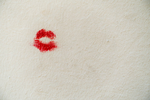 Red lips on a background in the shape of a kiss