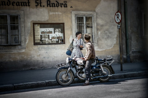 A couple outside on a motorcycle