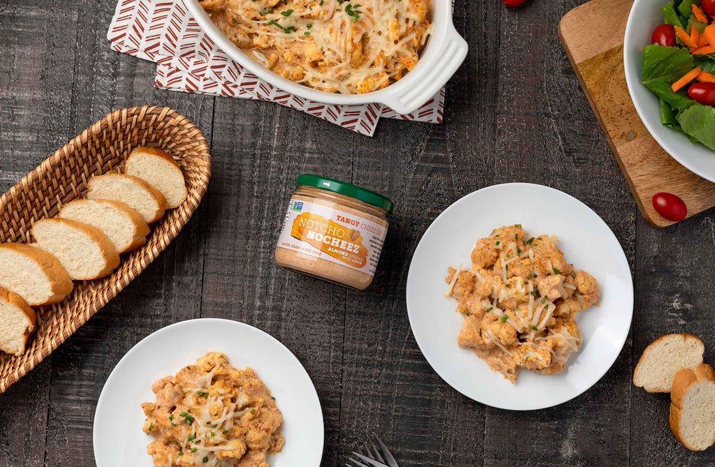 Plating of cauliflower mac & cheez with bread and Notcho Nocheez™ jar