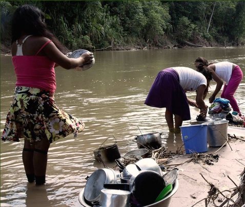 Huni Kuin Women gathering water from the polluted river in the Amazon Rainforest