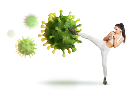 woman in white workout gear kicking a virus cell - strong immune system