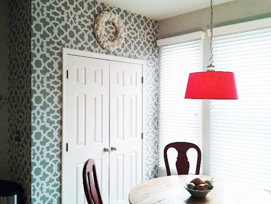 A gray and white stenciled eat in kitchen area using the Zamira Allover Stencil, a popular Moroccan wall pattern, from Cutting Edge Stencils. http://www.cuttingedgestencils.com/products/moroccan-stencil-designs