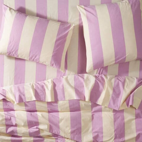 Sage and Clare purple stripe quilt cover, sheets and pillow cases on bed