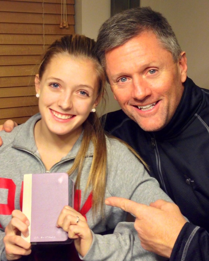 Coach Kyle Whittingham gives custom colored scriptures to children fo Christmas