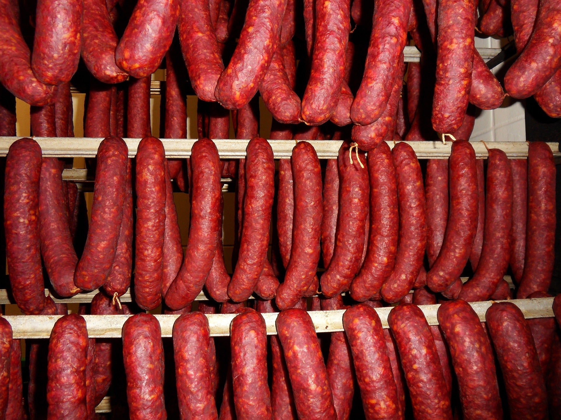 hanging sausage being cured in the smoke house