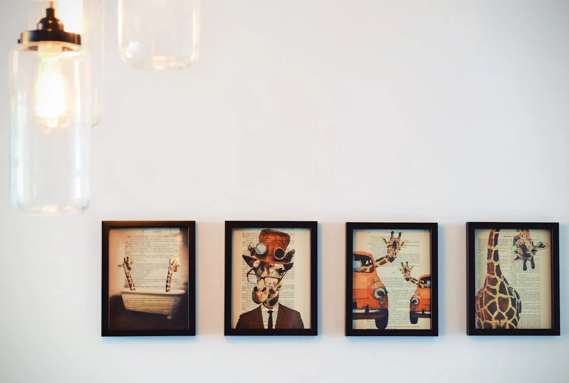 four wall paintings framed and placed in a line on a white wall