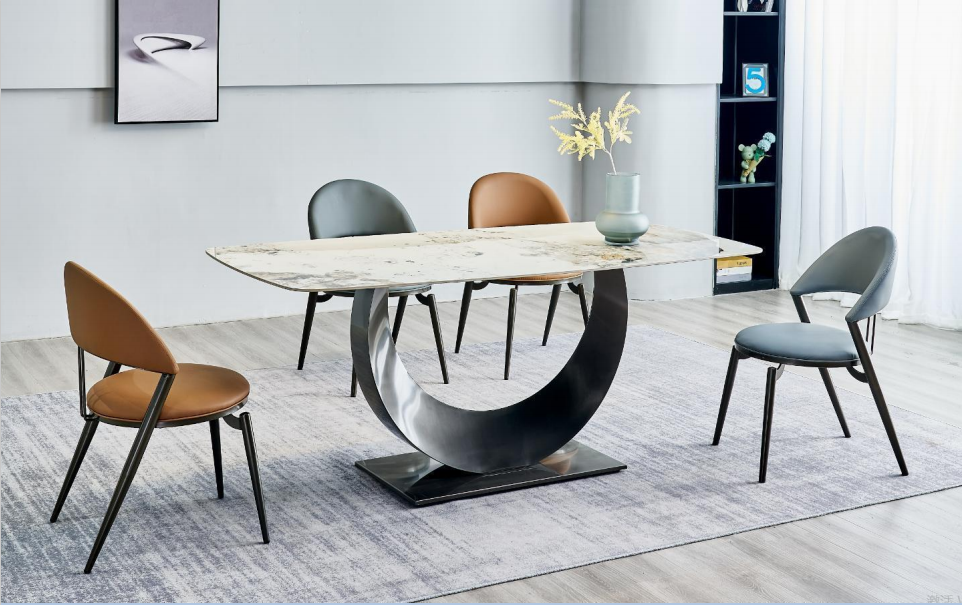 Our FT6111 is a perfect example of a designer dining table blending modern aesthetics with practical design. The table features a sintered stone top that complements any décor and ensures durability and resistance against daily wear and tear. The FT6111 dining table stands proud on a sturdy base that promises stability. Its sleek and polished surface, like the ocean's calm, offers ample space for entertaining and everyday dining. The neutral color palette and minimalistic design make it easy to incorporate into any design scheme or color theme. Experience the resilience of sintered stone and never worry about heavy loads or daily pressures as this table is not only designed to look beautiful but also to withstand the ravages of time. This piece of the designer dining table is a statement on its own, transforming an ordinary space into a stylish dining area.