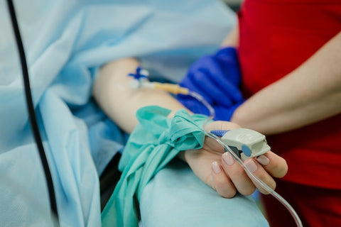 Hand of Hospital Patient Lying On Bed