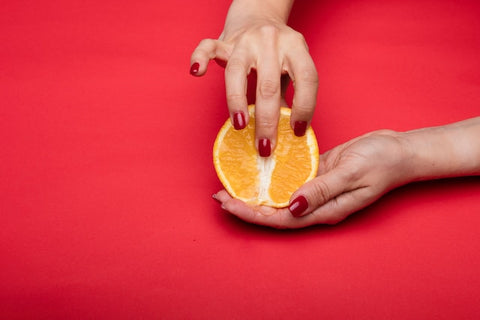 Person Holding Sliced Orange Fruit