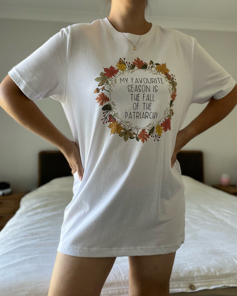 Woman wearing a white tshirt with a feminist quote on it