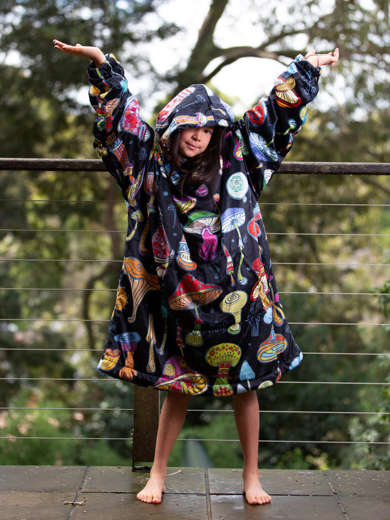 teenager girl wearing a magic mushroom hoodie blanket | Raiana's Vibes