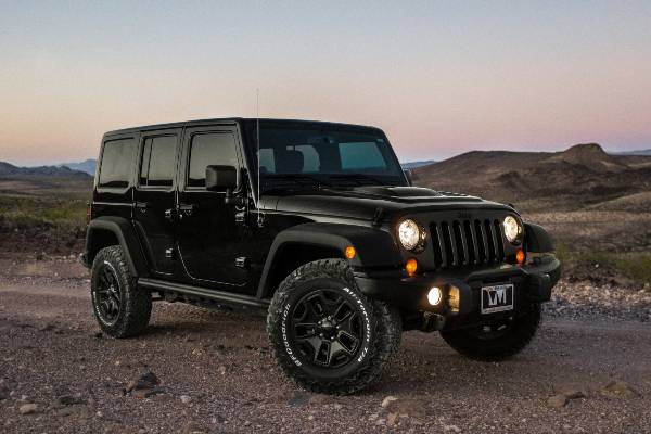 A black Jeep Wrangler parked on the road-1