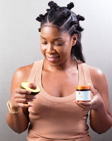 model holding avacado and Merin Kind Whipped Shea Butter