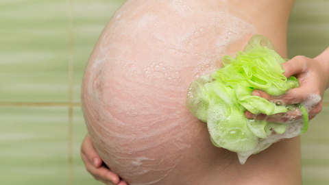 pregnant lady with loofa and soap