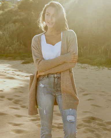 woman wearing a cardigan at the beach