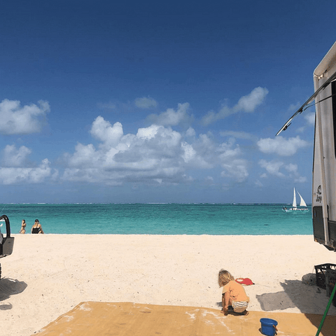 caravan and kids on a beach