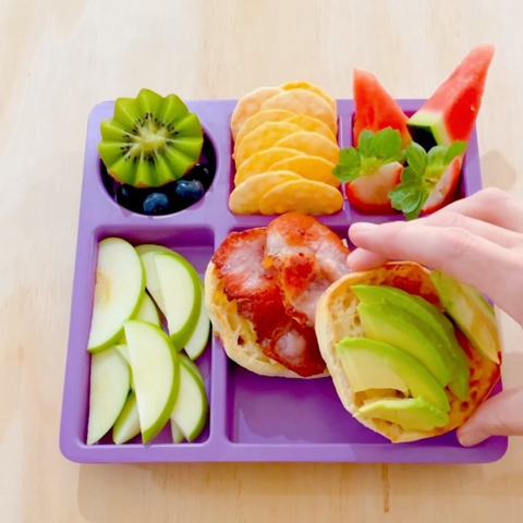 A purple bento plate with a simple lunch idea served on it