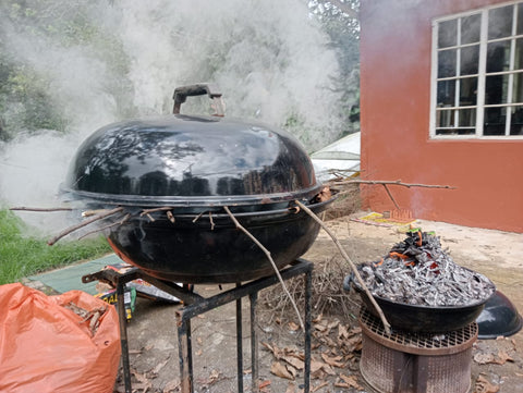 Smoking Weber braai in front of country studio