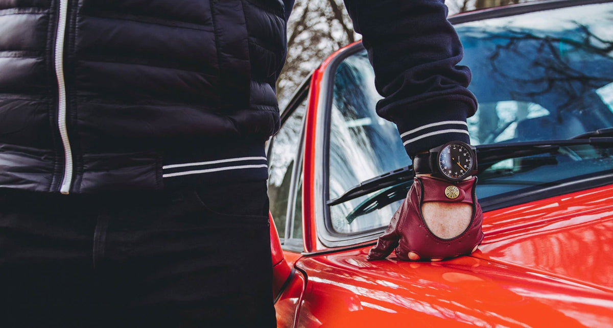 A person resting their hand on a car wearing a GRD Watch