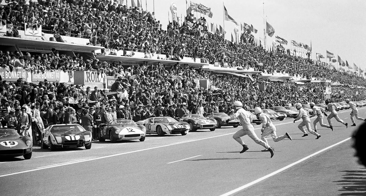 A period photo from Le Mans of drivers running to their cars