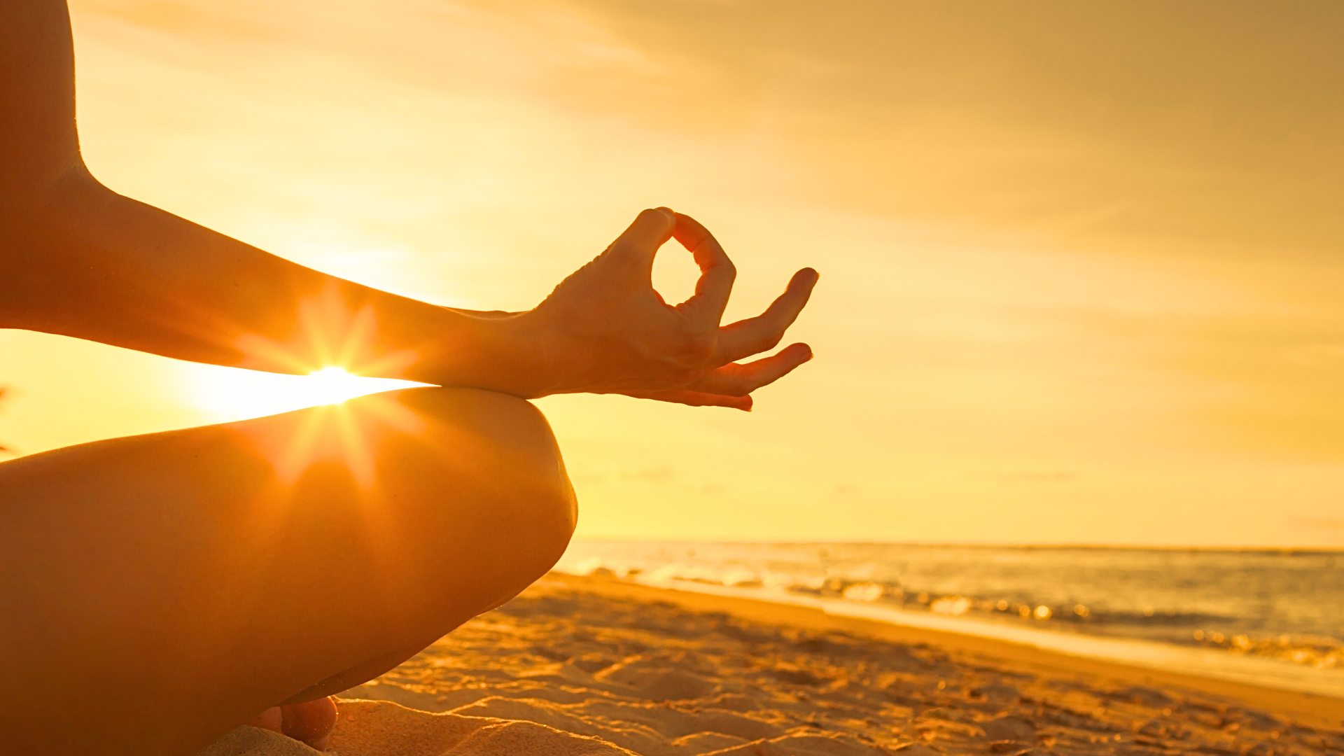 person meditating during the sunset