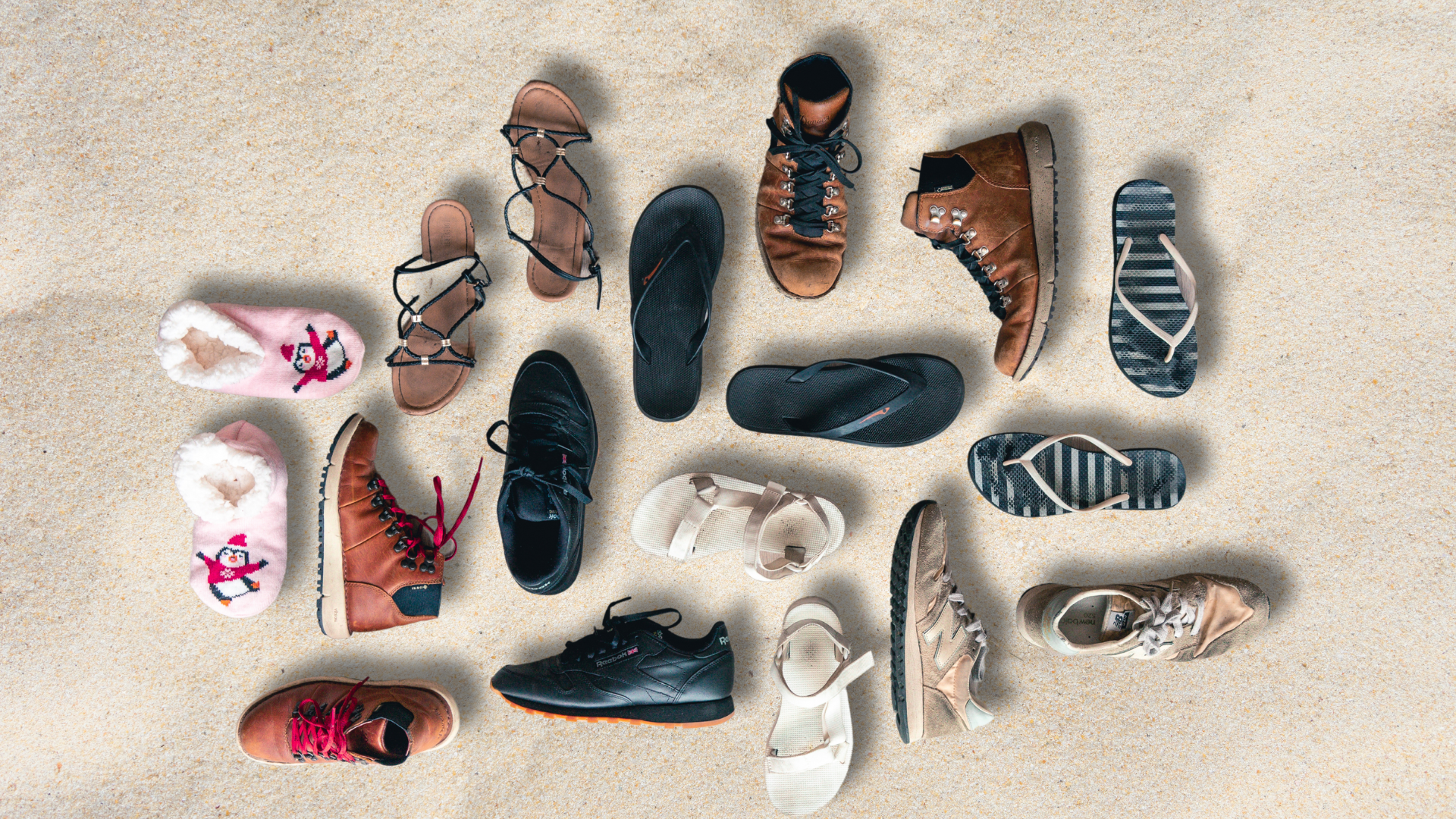 shoes and flip flops on the sand