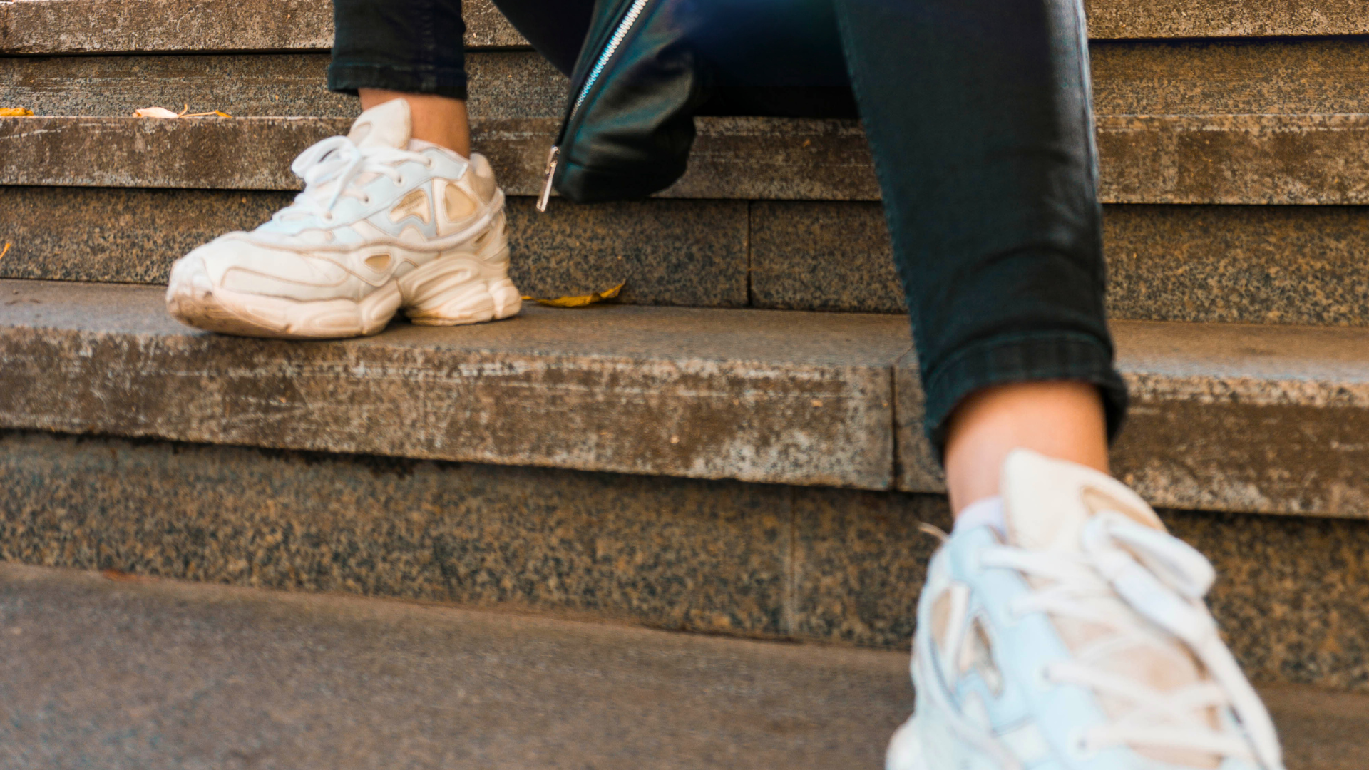 person wearing white shoes on stairs