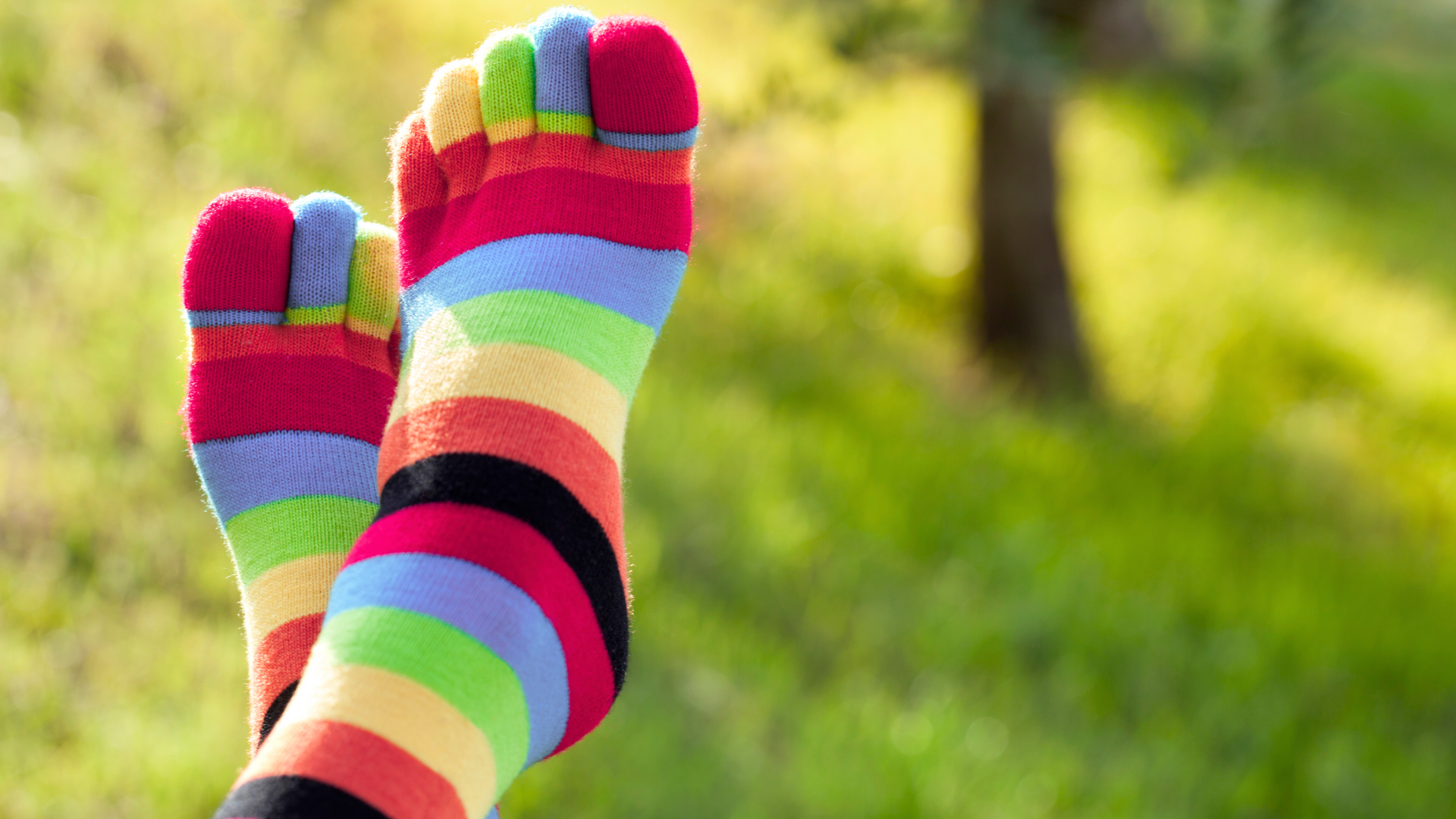 person wearing rainbow-colored socks